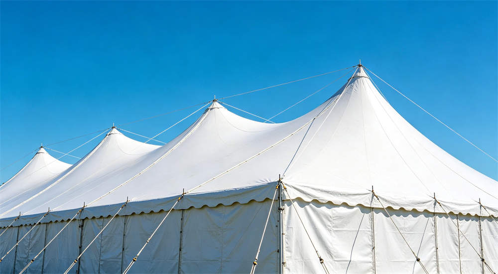 large frame tent exterior anchoring with guy lines blue sky