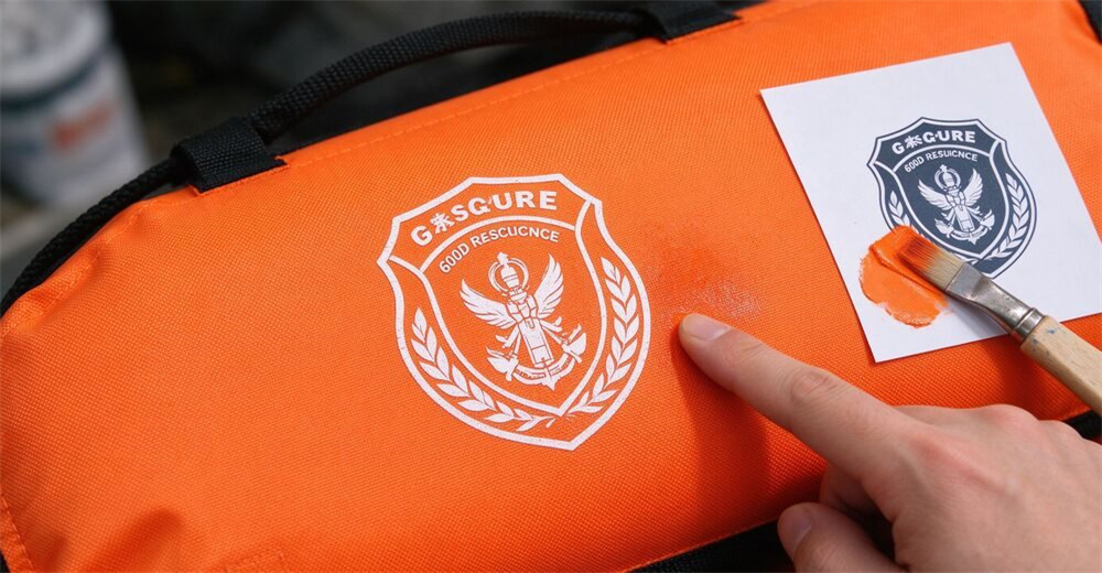 OEM custom logo silk-screen printing close-up on orange 600D Oxford fabric surface of foam-filled floating platform, showing customization service. Authentic water rescue floating platform product for professional flood rescue equipment and emergency water rescue operations.