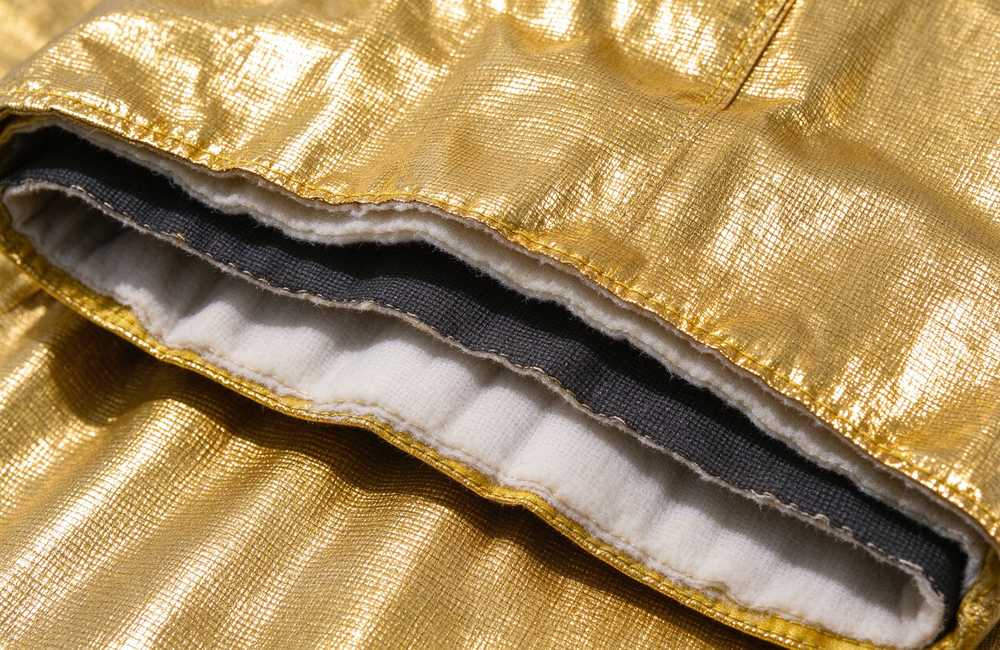 Overhead view of fire entry suit layer construction detail showing carbon fiber and insulation layers for extreme heat protection technology and fire entry suit quality inspection